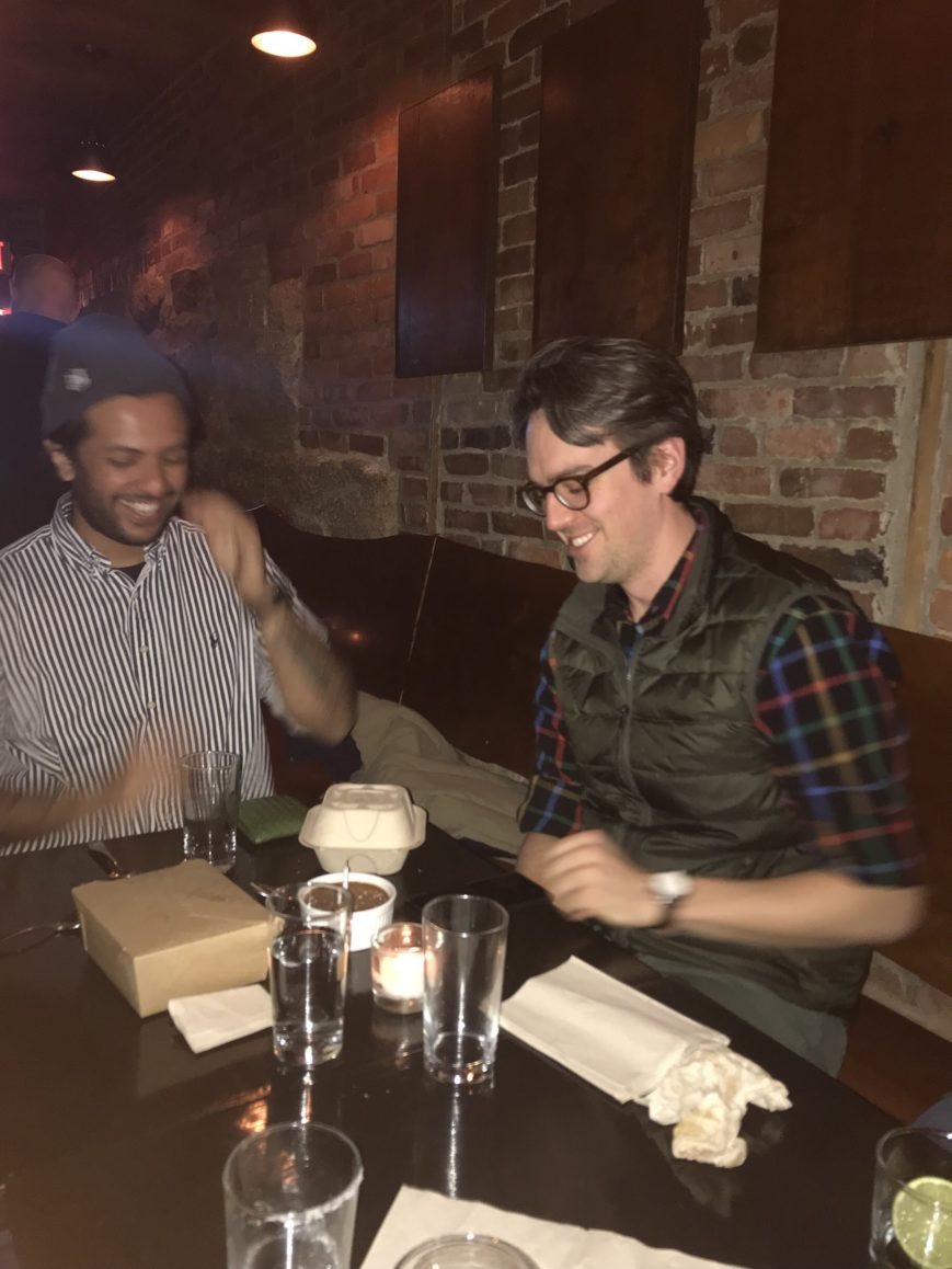 Two SWC employees laughing over dinner