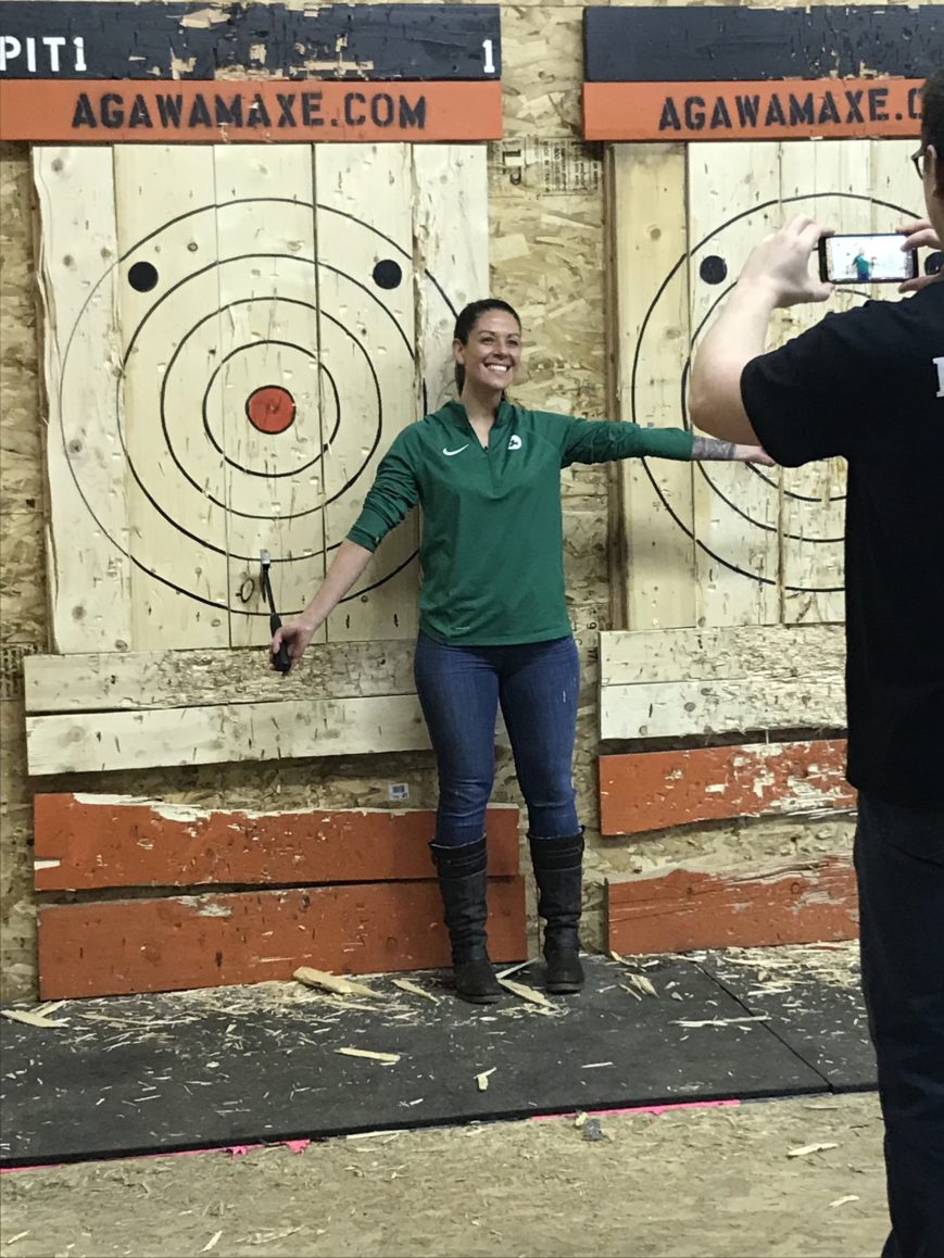 SWC staffer celebrating at an axe throwing event