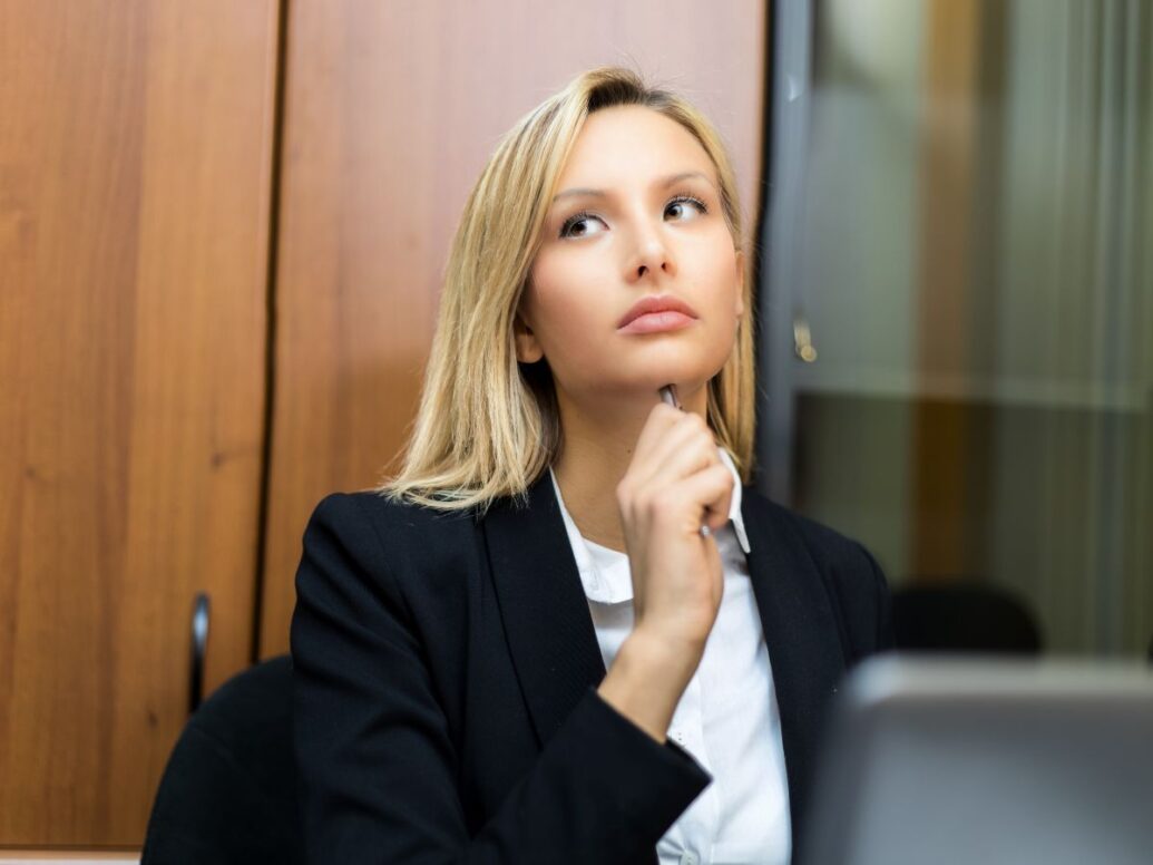 A blonde business woman contemplating how to get out of a merchant cash advance