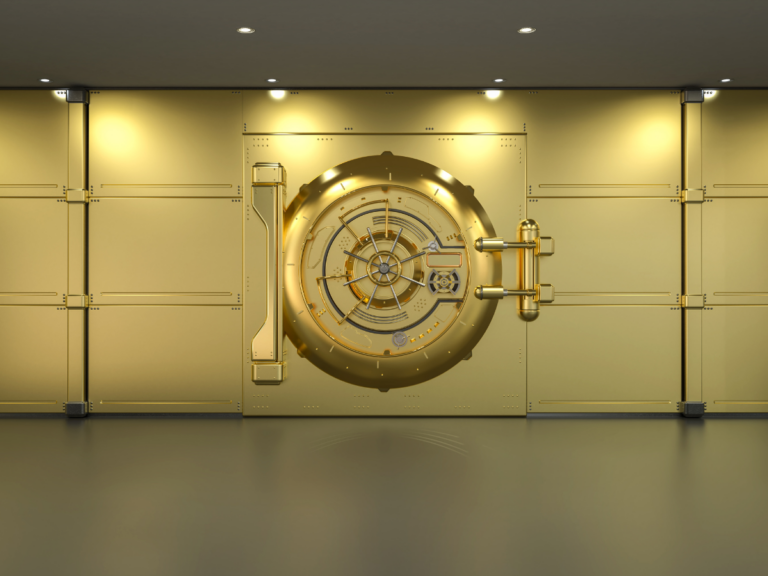 Claude responded: A large gold bank vault door set into a gold wall, illuminated by recessed ceiling lights.A large gold bank vault door set into a gold wall, illuminated by recessed ceiling lights.