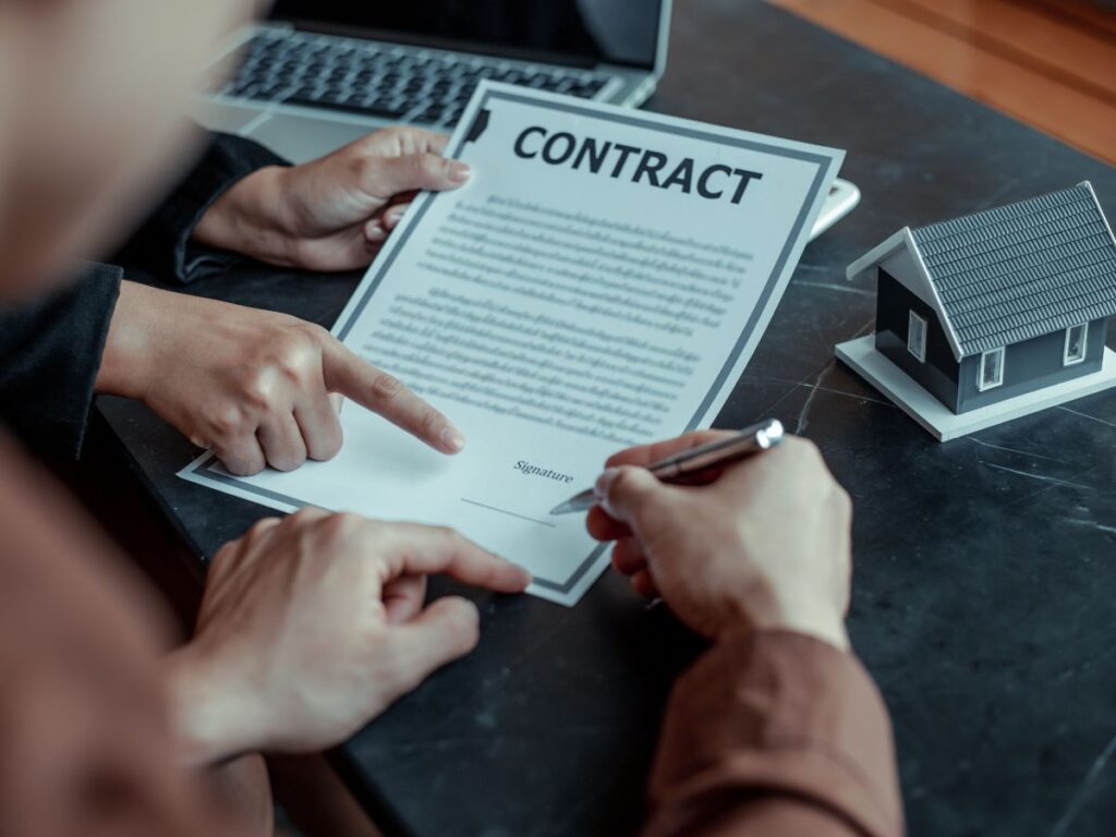 Business owner reviewing commercial loan covenants and merchant cash advance documents with a banker